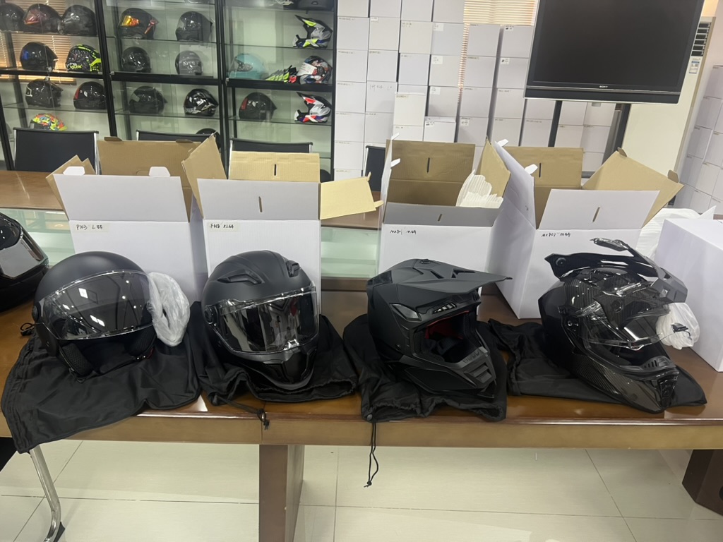 Several motorcycle helmet samples photographed during a Taotao business visit