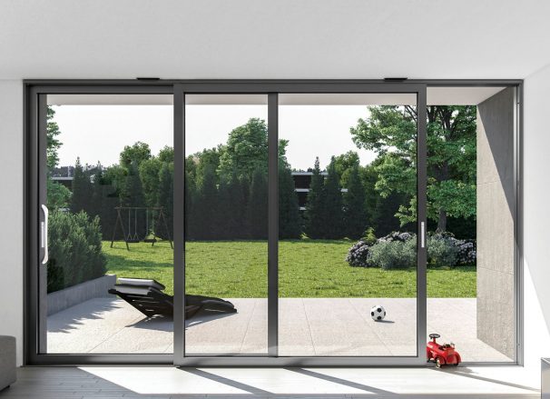 Black aluminum sliding patio door opening onto a garden terrace