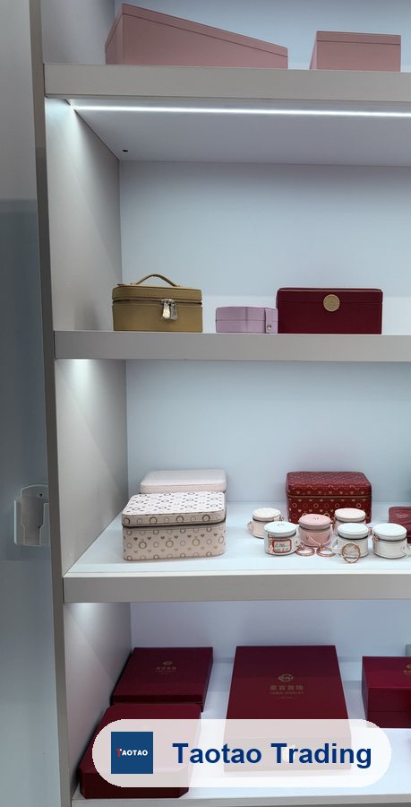 Assorted jewelry boxes and travel cases in a lit display cabinet