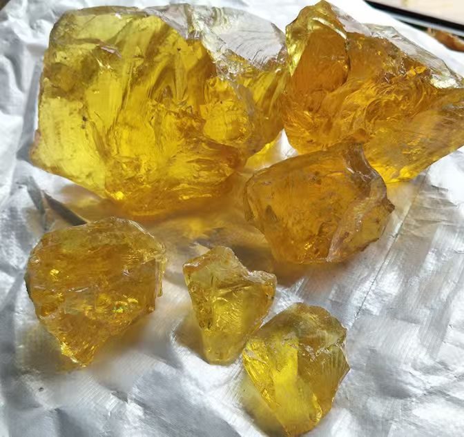 Pale yellow gum rosin chunks, close-up