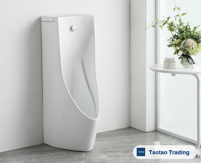 White ceramic floor-standing urinal in a modern bathroom